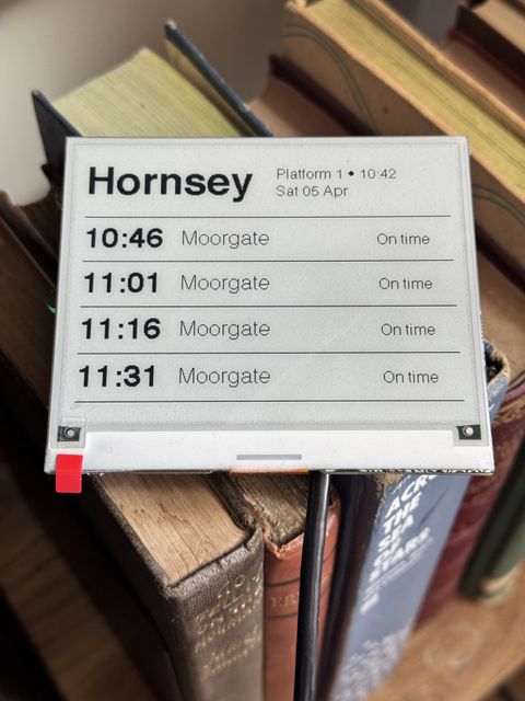 Picture of an eink screen showering train times