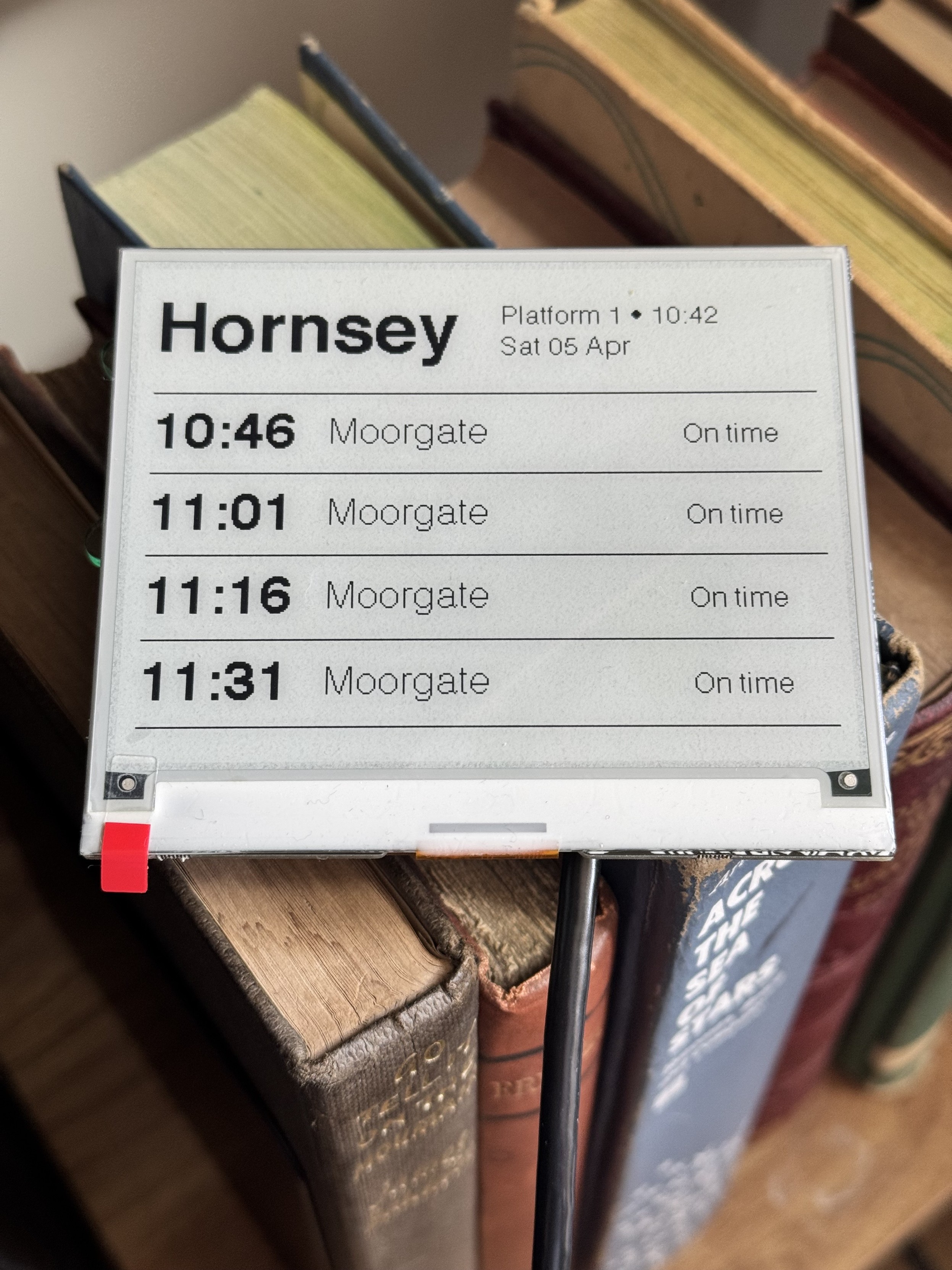 Picture of an eink screen showering train times